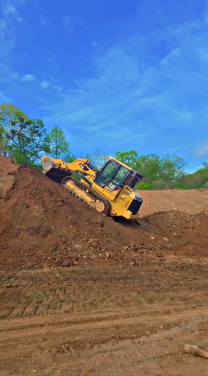 Dozer moving through an active dirt grading area