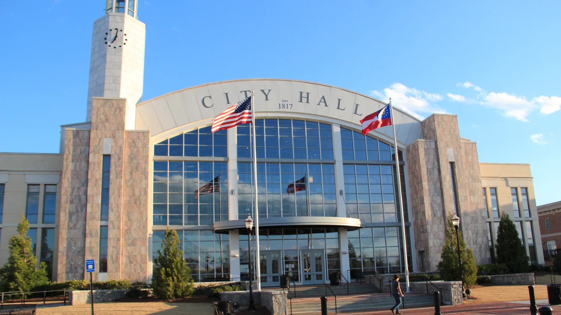 Suwanee City Hall framed by flags in Suwanee, Georgia.